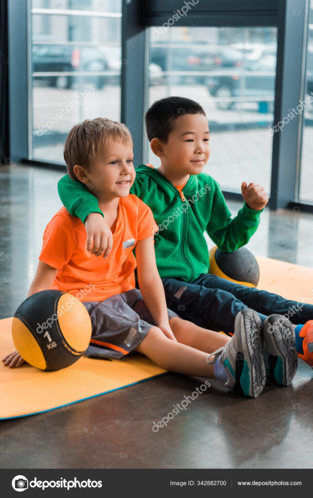 depositphotos_342882700-stock-photo-multiethnic-boys-smiling-hugging-sitting